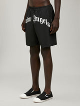 Palm AngelsCurved Logo swimshorts at Fashion Clinic